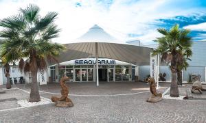 a building with two statues of animals in front of it at LE FLORIDE B Folco de baronchelli in Le Grau-du-Roi