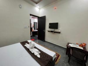 a hotel room with a bed with towels on it at Vraj waas in Mathura