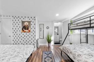 a bedroom with two beds and a wall at The Whimsical Estate in Bayonne