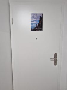a poster on the door of a white door at Haus Grimming in Öblarn