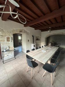 a large kitchen with a large wooden table and chairs at Gîte Entre Sources et Sapins 