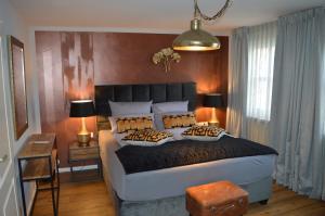 a bedroom with a large bed with pillows on it at Hotel Belvedere in Warnemünde