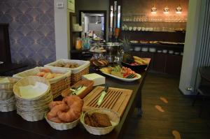 a table with baskets of bread and other food on it at Hotel Belvedere in Warnemünde