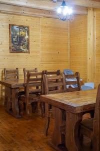 a dining room with wooden tables and chairs at Na Penkah in Yaremche