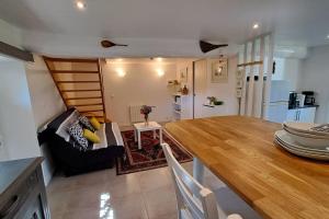 a kitchen and living room with a table and a couch at Chaumière de Kerréo, ELISA in Pluvigner +18 photos