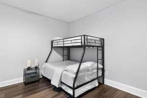 a black bunk bed in a white room at Modern Dream Loft in Bayonne