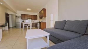 a living room with a couch and a table at STAY Skyline Nest in Larnaka