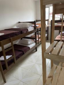 a room with three bunk beds in a room at Hostel Salus in Barueri