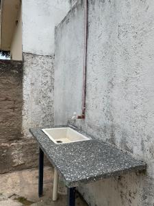 a stone table with a sink on a wall at Casa una habitación Mich VC Santa María de Punilla in Bialet Massé