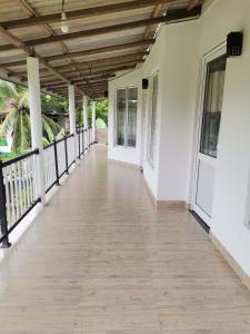 a corridor of a house with a wooden ceiling at Sunfa Resort in Ambalantota