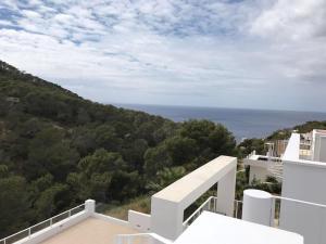 a view of the ocean from the balcony of a house at Chalet en C.Vadella - Piscina privada in Cala Vadella