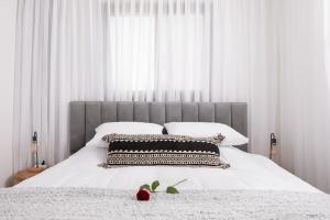 a bedroom with a large white bed with white pillows at סוויטה מרווחת, רומנטית ומפנקת in Eilat