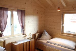 a room with two windows in a log cabin at Chalet Charmant-Santelmann in Bischoffingen