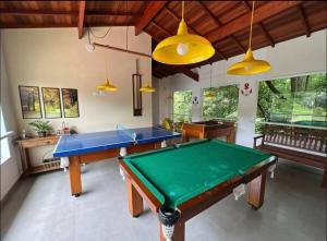 a living room with a pool table in it at Linda Casa em uma linda praia - Santiago/ Maresias in São Sebastião