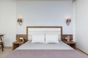 a bedroom with a large bed with two night stands at Iris Hotel in Siviri