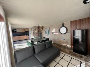 a living room with a couch and a table at Casa Da Eira in Santo Emilião