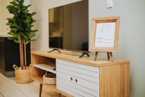 a dresser with a tv on top of it at @Kruger in White River