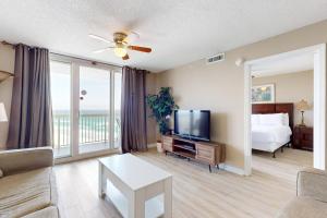 a living room with a couch and a tv and a bed at The Resorts Of Pelican Beach 1413 Destin (Condo) in Destin