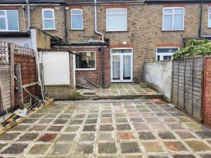 an empty courtyard in front of a brick building at Comfy Guest House in London