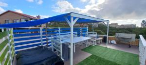 a blue canopy on the roof of a house at King Protea Self Catering Flat in Mossel Bay