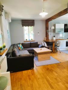 a living room with a couch and a table at Ostoja Kaczórki in Kaczórki