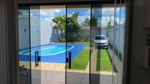 samochód zaparkowany przed domem z basenem w obiekcie Pousada Ferreira w mieście São Gabriel