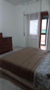 a bedroom with a bed and a dresser and a window at La terrazza nel centro in Rome