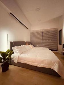 a bedroom with a large bed with a large window at Pavilion Bukit Jalil Revo@Aurora By D'Summer91 in Kuala Lumpur