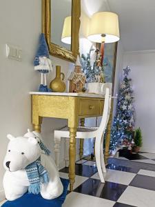 a white teddy bear sitting next to a desk with a christmas tree at ATTIC BAY in Câmara de Lobos