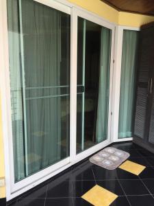 a room with a large glass window with a mat on the floor at Jomtien Plaza Residence B408 By Mr.Kiss in Jomtien Beach