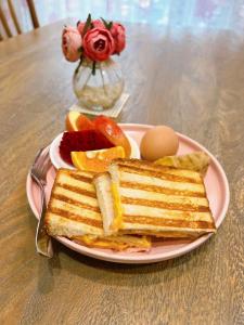a plate of toast and fruit and eggs on a table at chance encounter in Luodong
