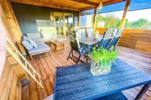 a wooden deck with a table and chairs on it at Rosé de Lux in Bogács