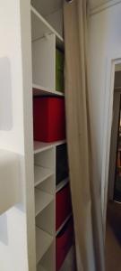 a closet with white shelves and a curtain at STUDIO COSY ISARD P2000 in Bolquere Pyrenees 2000