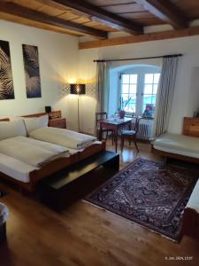 Beromünster的住宿－Gasthaus "Hotel Hirschen"，一间卧室配有一张床铺和一张桌子,另一间卧室配有一张桌子。