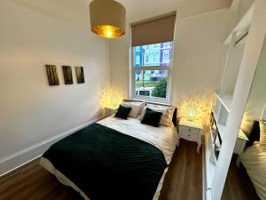 a bedroom with a bed and a window at The Look-out! Park Hills Beach in Hastings