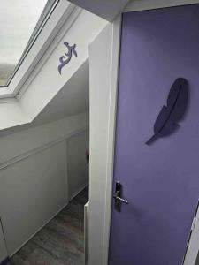 a room with a purple door with a butterfly on it at Purple Baroque Rer C -N104-A6 in Brétigny-sur-Orge