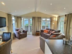 a living room with two couches and a television at Arnside 5 in Warton