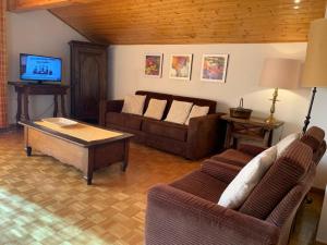 a living room with a couch and a coffee table at Crans Montana spacious 80m2 apartment with stunning view & bus stop outside in Crans-Montana