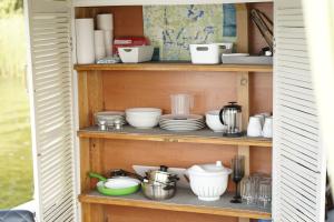 a shelf with dishes and other items on it at Floss Priepert 1 in Priepert