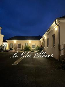 a building with a sign that says he does autism at Le Clos Albert in Loudun