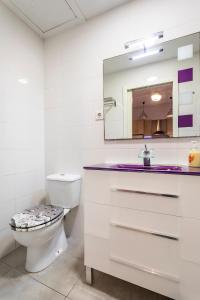 バレンシアにあるAPARTAMENTO DE ENSUEÑOの白いバスルーム(トイレ、鏡付)