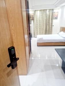 a door to a room with a bed and a phone at Holikeys - Rabat - 1 Ch - Agdal 006 in Rabat