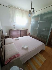 a bedroom with a large bed and a dresser at Betty casa vacanza in Aradeo