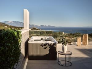 a sink and a table and a vase on a balcony at Ocean Luxury Villas in Volímai