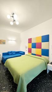 a bedroom with a large bed with a colorful headboard at B&B Vittoria in Maiori
