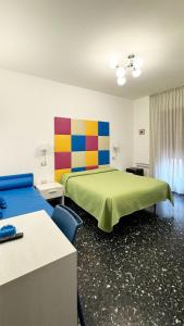 a hotel room with two beds and a colorful wall at B&B Vittoria in Maiori