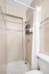 a bathroom with a shower and a toilet at Prime Location at Condado Beach 1br 1ba - Apt 8 in San Juan