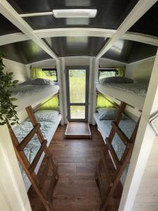 a room with three bunk beds in a tiny house at Floss Priepert 2 in Priepert