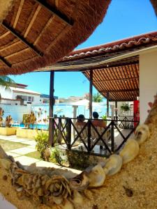 a view of the ocean from a resort with a beach at Pousada Flor de Lótus Suites Carneiros in Tamandaré