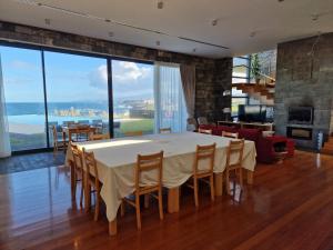 a dining room with a table and chairs and a fireplace at São Vicente Lodge - Panoramic Retreat in Capelas